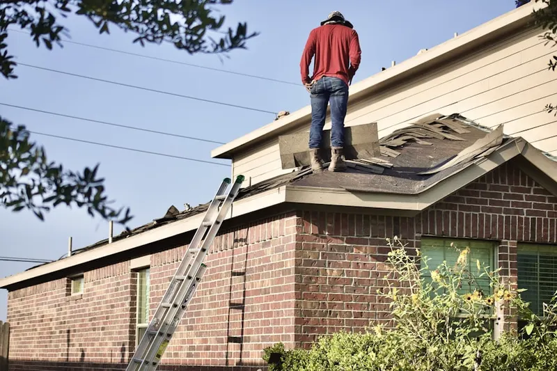 Professional roofer working on a residential roof in Running Springs